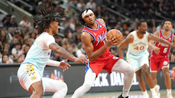 Mar 21, 2025; San Antonio, Texas, USA; Philadelphia 76ers guard Ricky Council IV (14) dribbles against San Antonio Spurs guard Stephon Castle (5) during the fourth quarter at Frost Bank Center. Mandatory Credit: Dustin Safranek-Imagn Images