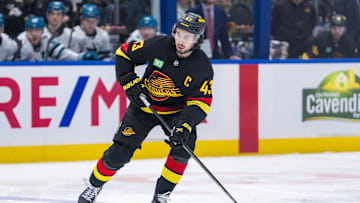 Dec 23, 2024; Vancouver, British Columbia, CAN; Vancouver Canucks defenseman Quinn Hughes (43) handles the puck against the San Jose Sharks during the first period at Rogers Arena. Mandatory Credit: Bob Frid-Imagn Images