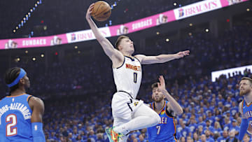 May 18, 2025; Oklahoma City, Oklahoma, USA; Denver Nuggets guard Christian Braun (0) goes to the basket against the Oklahoma City Thunder in the first quarter during game seven of the second round for the 2025 NBA Playoffs at Paycom Center. Mandatory Credit: Alonzo Adams-Imagn Images