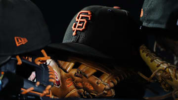 Sep 2, 2025; Denver, Colorado, USA;  General view of San Francisco Giants caps and gloves during the sixth inning against the Colorado Rockies at Coors Field. Mandatory Credit: Ron Chenoy-Imagn Images