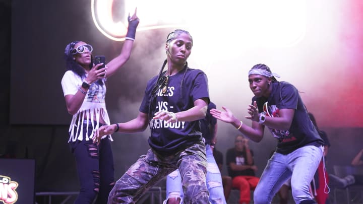 Oct 23, 2023; Las Vegas, NV, USA; Las Vegas Aces guards Sydney Colson (51), Chelsea Gray (12) and forward Aja Wilson (22) celebrate during the Las Vegas Aces championship parade at Toshiba Plaza. 