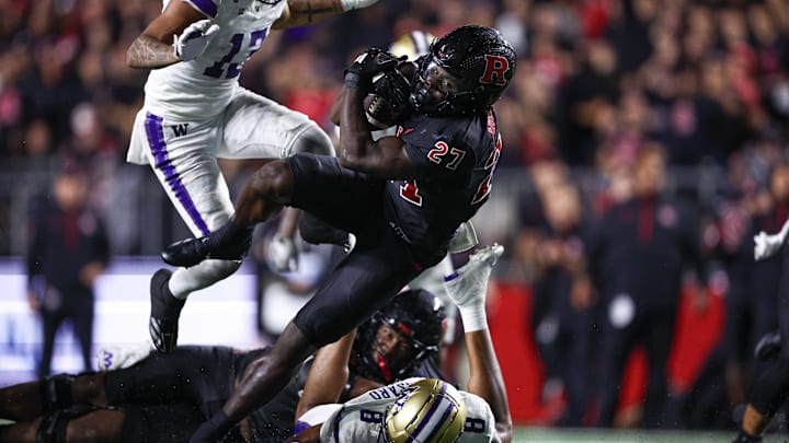Sep 27, 2024; Piscataway, New Jersey, USA; Rutgers Scarlet Knights running back Samuel Brown V (27) breaks a tackle by Washington Huskies safety Cameron Broussard (8) for a touchdown reception during the second half at SHI Stadium. Mandatory Credit: Vincent Carchietta-Imagn Images Sep 27, 2024; Piscataway, New Jersey, USA; Rutgers Scarlet Knights running back Samuel Brown V (27) breaks a tackle by Washington Huskies safety Cameron Broussard (8) for a touchdown reception during the second half at SHI Stadium. Mandatory Credit: Vincent Carchietta-Imagn Images