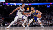 Apr 16, 2024; Sacramento, California, USA; Golden State Warriors guard Stephen Curry (30) is guarded by Sacramento Kings forward Keegan Murray (13).
