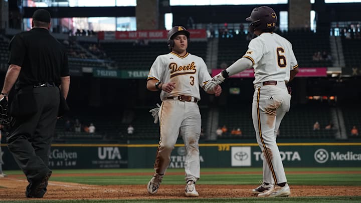 Feb 28, 2026; Arlington, TX, USA; Landon Hairston (left) high-fives Nu'u Contrades against the Tennessee Volunteers during the Amegy Bank College Baseball Series at Globe Life Field. 