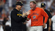 Oct 18, 2025; Auburn, Alabama, USA; Missouri Tigers head coach Eli Drinkwitz and Auburn Tigers head coach Hugh Freeze speak before the game at Jordan-Hare Stadium. Mandatory Credit: John Reed-Imagn Images
