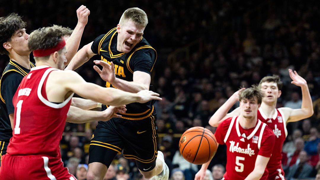Nebraska guard Sam Hoiberg (1) and Braden Frager (5) defend Iowa guard Bennett Stirtz (14) at Carver-Hawkeye Arena in Iowa City.
