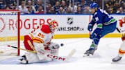 Apr 16, 2024; Vancouver, British Columbia, CAN; Calgary Flames goalie Jacob Markstrom (25) makes a save on Vancouver Canucks forward Dakota Joshua (81) in the third period at Rogers Arena. Canucks won 4 -1. Mandatory Credit: Bob Frid-USA TODAY Sports