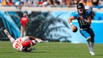 Jacksonville Jaguars quarterback Trevor Lawrence (16) runs past Kansas City Chiefs defensive end George Karlaftis (56) during the fourth quarter of a NFL football game Sunday, Sept. 17, 2023 at EverBank Stadium in Jacksonville, Fla. The Kansas City Chiefs defeated the Jacksonville Jaguars 17-9. [Corey Perrine/Florida Times-Union]