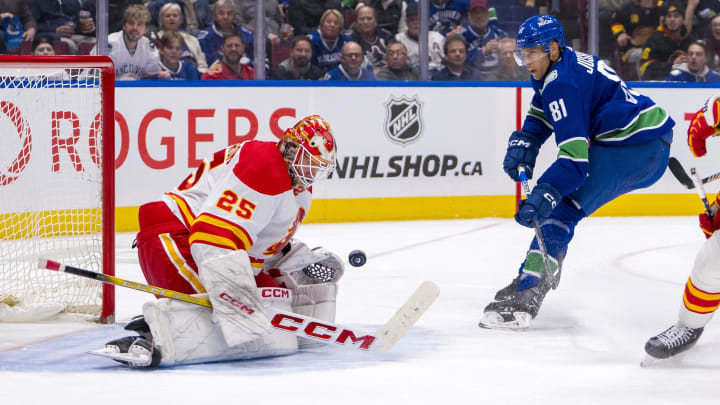 Apr 16, 2024; Vancouver, British Columbia, CAN; Calgary Flames goalie Jacob Markstrom (25) makes a save on Vancouver Canucks forward Dakota Joshua (81) in the third period at Rogers Arena. Canucks won 4 -1. Mandatory Credit: Bob Frid-USA TODAY Sports