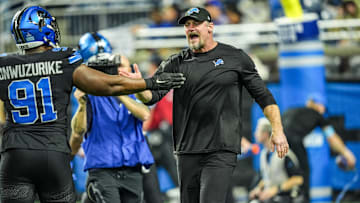 Detroit Lions head coach Dan Campbell greets players during warmups at Ford Field in Detroit on Sunday, Dec. 15, 2024.