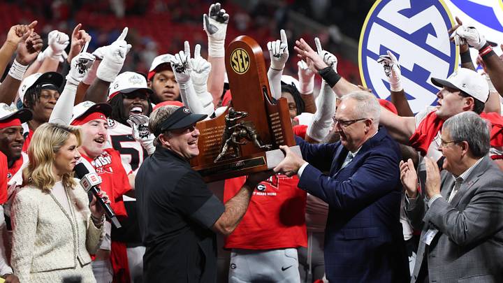 Dec 6, 2025; Atlanta, GA, USA; Georgia Bulldogs head coach Kirby Smart lifts the SEC Championship trophy after the game against the Alabama Crimson Tide during the 2025 SEC Championship game at Mercedes-Benz Stadium. Mandatory Credit: Brett Davis-Imagn Images