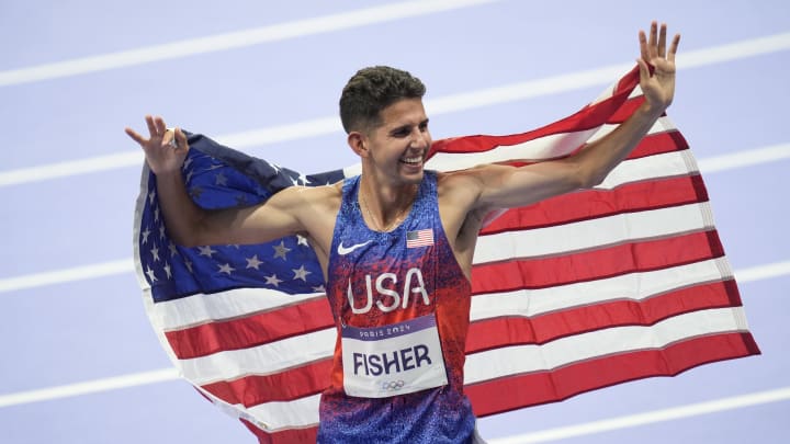 Aug 2, 2024; Paris, FRANCE; Grant Fisher (USA) celebrates his third place finish in the men's 10,000m final during the Paris 2024 Olympic Summer Games at Stade de France. Mandatory Credit: Andrew Nelles-USA TODAY Sports