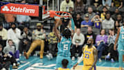 Jan 27, 2025; Charlotte, North Carolina, USA; Charlotte Hornets center Mark Williams (5) dunks the ball against Los Angeles Lakers forward LeBron James (23) during the second half at the Spectrum Center. Mandatory Credit: Jim Dedmon-Imagn Images
