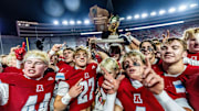 Arrowhead players celebrate with the gold trophy after defeating Bay Port, 18-15, in the WIAA Division 1 state football championship game at Camp Randall Stadium in Madison on Friday, Nov. 21, 2025.