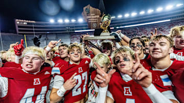 Arrowhead players celebrate with the gold trophy after defeating Bay Port, 18-15, in the WIAA Division 1 state football championship game at Camp Randall Stadium in Madison on Friday, Nov. 21, 2025.