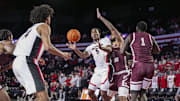 Nov 10, 2024; Athens, Georgia, USA; Georgia Bulldogs guard Silas Demary Jr. (5) passes there ball to forward Asa Newell (14) against Texas Southern Tigers forward Grayson Carter (25) during the first half at Stegeman Coliseum. Mandatory Credit: Dale Zanine-Imagn Images