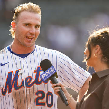 Sep 14, 2025; New York City, New York, USA; New York Mets first baseman Pete Alonso (20) conducts an interview after hitting a walk off three run home run against the Texas Rangers during the tenth inning at Citi Field. Mandatory Credit: Gregory Fisher-Imagn Images