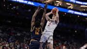 Mar 11, 2025; Charlotte, NC, USA; Virginia Tech Hokies guard Jaden Schutt (2) goes to the basket defended by California Golden Bears center Mady Sissoko (12) during the second half at Spectrum Center. Mandatory Credit: Jim Dedmon-Imagn Images