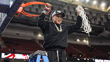 March 9, 2025; Greenville, SC, USA;  South Carolina Gamecocks head coach Dawn Staley cuts the net down  after the win over Texas in the SEC womenís championship  at Bon Secours Wellness Arena. Mandatory Credit: Jim Dedmon-Imagn Images