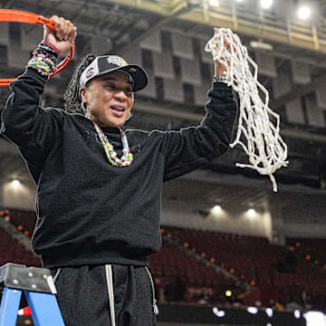 March 9, 2025; Greenville, SC, USA;  South Carolina Gamecocks head coach Dawn Staley cuts the net down  after the win over Texas in the SEC womenís championship  at Bon Secours Wellness Arena. Mandatory Credit: Jim Dedmon-Imagn Images