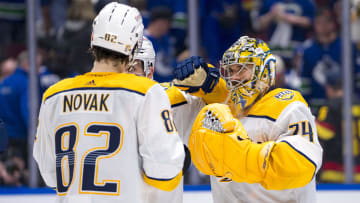 Apr 30, 2024; Vancouver, British Columbia, CAN; Nashville Predators forward Tommy Novak (82) and goalie Juuse Saros (74) celebrate the victory against the Vancouver Canucks at the end of game five of the first round of the 2024 Stanley Cup Playoffs at Rogers Arena. Mandatory Credit: Bob Frid-USA TODAY Sports
