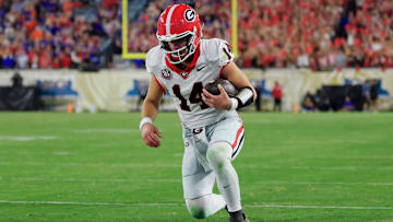 Georgia Bulldogs quarterback Gunner Stockton (14) kneels before the goal line to pick up the first down and run out the clock during the fourth quarter of an NCAA football game, Saturday, Nov. 1, 2025, at EverBank Stadium in Jacksonville, Fla. Georgia held off Florida 24-20. [Corey Perrine/Florida Times-Union]