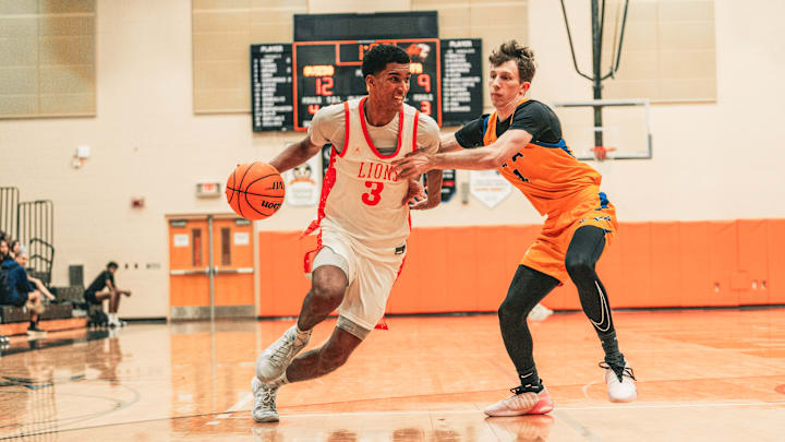 Oviedo High's Cameron Bryant (3) looks for an opening in a recent game. Later, the 6-foot-6 senior went on to tally 22 points and 13 rebounds for a double-double to power the Lions past Lake Howell, 66-44.