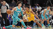 Jan 27, 2025; Charlotte, North Carolina, USA; Charlotte Hornets guard LaMelo Ball (1) handles the ball against Los Angeles Lakers guard Max Christie (12) during the first quarter at the Spectrum Center. Mandatory Credit: Jim Dedmon-Imagn Images