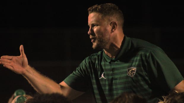 Nease head coach Collin Drafts speaks with his team after defeating Creekside 45-7 in a high school football game on August 3