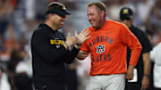Oct 18, 2025; Auburn, Alabama, USA; Missouri Tigers head coach Eli Drinkwitz and Auburn Tigers head coach Hugh Freeze speak before the game at Jordan-Hare Stadium. Mandatory Credit: John Reed-Imagn Images