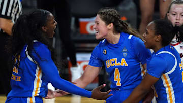 Mar 5, 2021; Las Vegas, NV, USA; UCLA Bruins forward Michaela Onyenwere (21) and guard Lindsey Corsaro (4) and guard Charisma Osborne (20) celebrate in the second half against the Arizona Wildcats during a Pac-12 Conference women's tournament semifinal at Mandalay Bay Events Center. Mandatory Credit: Kirby Lee-Imagn Images
