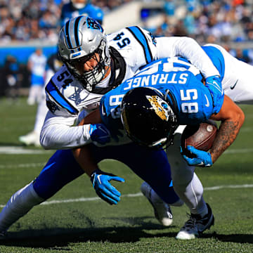 Carolina Panthers linebacker Kamu Grugier-Hill (54) tackles Jacksonville Jaguars tight end Brenton Strange (85) during the second quarter of a regular season NFL football matchup Sunday, Dec. 31, 2023 at EverBank Stadium in Jacksonville, Fla. The Jacksonville Jaguars blanked the Carolina Panthers 26-0. [Corey Perrine/Florida Times-Union]