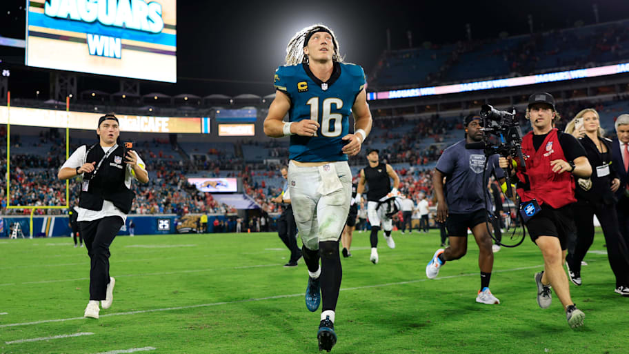 Trevor Lawrence runs off the field after a game