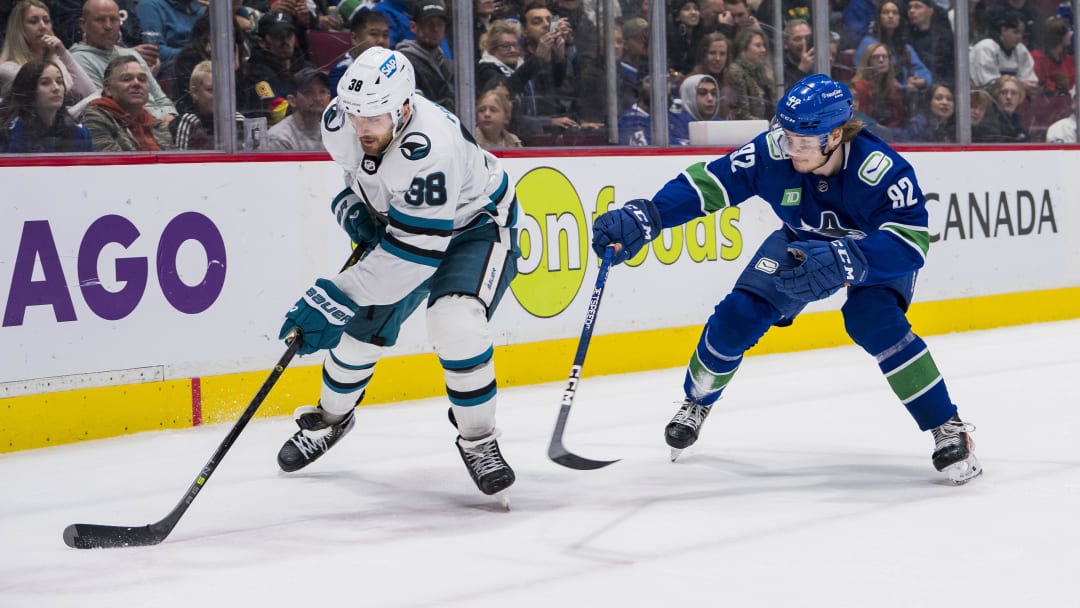 Mar 23, 2023; Vancouver, British Columbia, CAN; Vancouver Canucks forward Vasily Podkolzin (92) pursues San Jose Sharks defenseman Mario Ferraro (38) in the third period at Rogers Arena. Canucks won 7-2. Mandatory Credit: Bob Frid-USA TODAY Sports