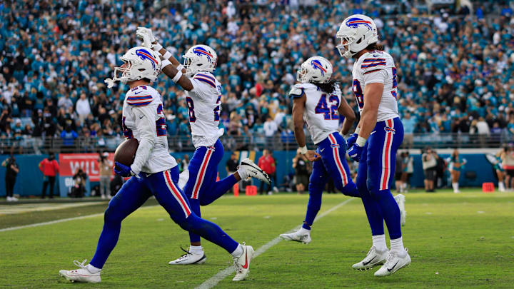 Buffalo Bills safety Cole Bishop (24), from left, celebrates his interception, sealing the game, with safety Sam Franklin Jr. (28), linebacker Dorian Williams (42) and linebacker Matt Milano (58), during the fourth quarter of an NFL football AFC Wild Card playoff matchup, Sunday, Jan. 11, 2026, in Jacksonville, Fla. The Bills defeated the Jaguars 27-24. [Corey Perrine/Florida Times-Union]