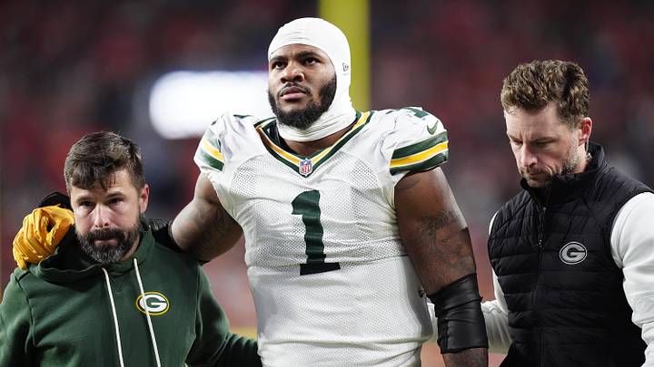 Dec 14, 2025; Denver, Colorado, USA; Green Bay Packers defensive end Micah Parsons (1) walks off the field with help from medical personnel following an injury during the third quarter against the Denver Broncos at Empower Field at Mile High. Mandatory Credit: Ron Chenoy-Imagn Images