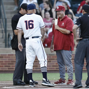 Jun 1, 2024; Norman, OK, USA; UConn Huskies head coach Jim Penders, left, and Oklahoma Sooners head coach Skip Johnson, right, meet before the start of an NCAA Division I Baseball Championship game between the UConn Huskies and the Oklahoma Sooners at L. Dale Mitchell Park. Credit: Alonzo Adams-USA TODAY Sports