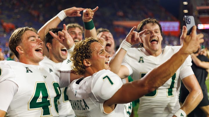 South Florida Bulls place kicker Nico Gramatica, long snapper Turner McLaughlin, and teammates celebrate.