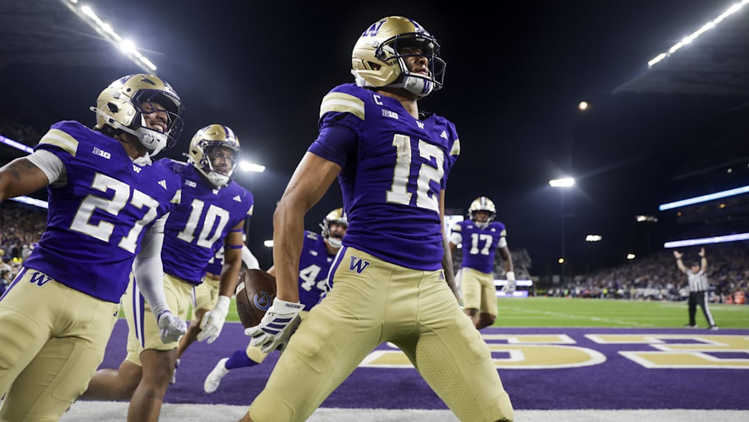 Sep 6, 2025; Seattle, Washington, USA; Washington Huskies wide receiver Denzel Boston (12) celebrates after returning a punt for a touchdown against the UC Davis Aggies during the second quarter at Husky Stadium. Washington Huskies safety Vincent Holmes (27) and linebacker Xe'ree Alexander (10) follow behind Boston. Mandatory Credit: Joe Nicholson-Imagn Images