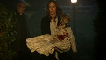 (L-R) STEVE COULTER as Father Gordon, VERA FARMIGA as Lorraine Warren and the Annabelle doll in New Line Cinema’s horror film “ANNABELLE COMES HOME,” a Warner Bros. Pictures release.