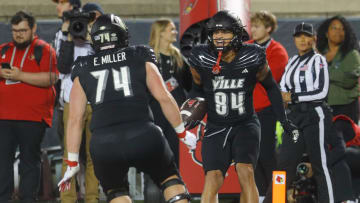 Louisville   s Joey Gatewood, #84, gets ready to jump with Eric Miller after he scored a touchdown