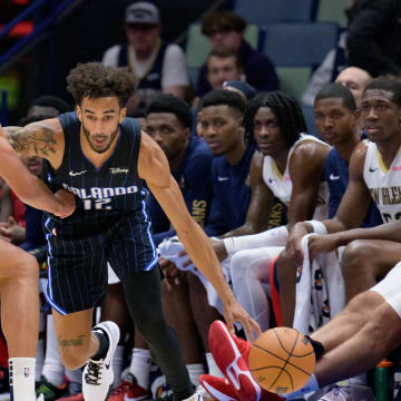 Oct 10, 2023; New Orleans, Louisiana, USA; Orlando Magic guard Trevelin Queen (12) dribbles against New Orleans Pelicans forward Kaiser Gates (12) during the fourth quarter at the Smoothie King Center. Mandatory Credit: Matthew Hinton-USA TODAY Sports