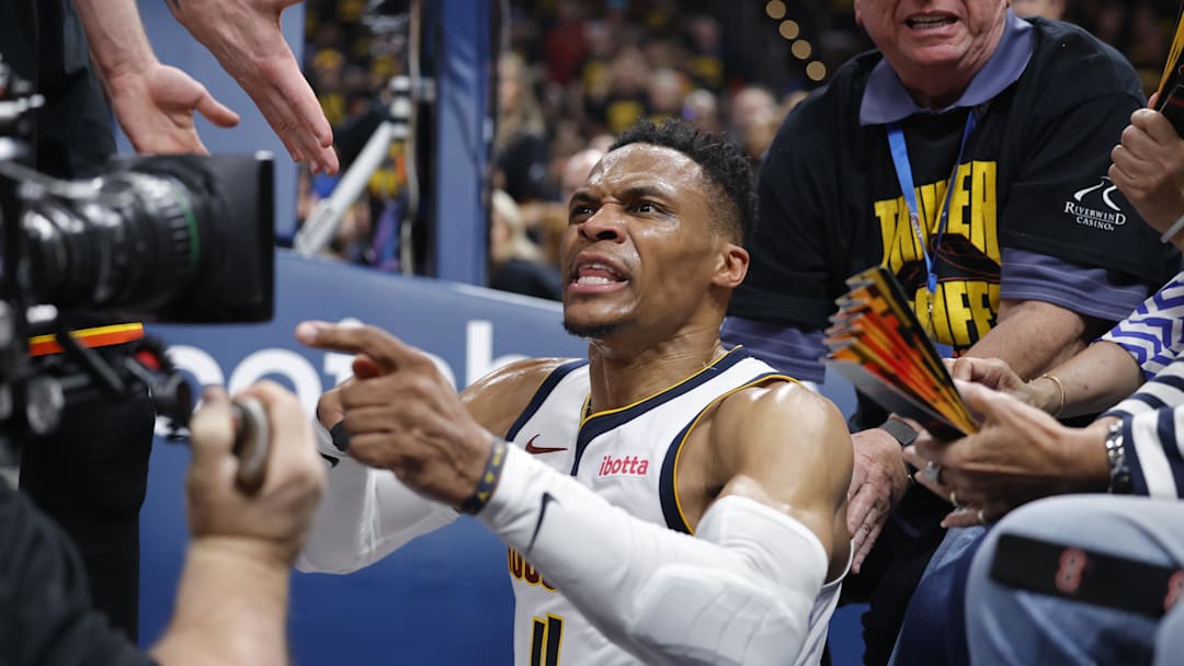 May 7, 2025; Oklahoma City, Oklahoma, USA; Denver Nuggets guard Russell Westbrook (4) reacts after a play and falling into fans in the second quarter against the Oklahoma City Thunder during game two of the second round for the 2025 NBA Playoffs at Paycom Center. Mandatory Credit: Alonzo Adams-Imagn Images