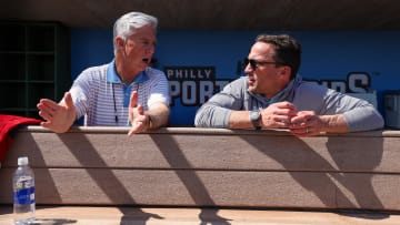 Feb 25, 2024; Clearwater, Florida, USA;  Philadelphia Phillies president of baseball operations Dave Dombrowski and general manager Sam Fuld talk in the dugout before a game against the New York Yankees at BayCare Ballpark. Mandatory Credit: Nathan Ray Seebeck-USA TODAY Sports