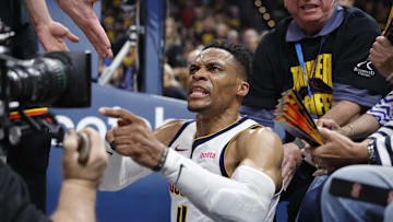 May 7, 2025; Oklahoma City, Oklahoma, USA; Denver Nuggets guard Russell Westbrook (4) reacts after a play and falling into fans in the second quarter against the Oklahoma City Thunder during game two of the second round for the 2025 NBA Playoffs at Paycom Center. Mandatory Credit: Alonzo Adams-Imagn Images