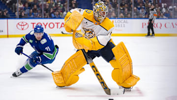 Jan 3, 2025; Vancouver, British Columbia, CAN; Vancouver Canucks forward Nils Hoglander (21) watches Nashville Predators goalie Juuse Saros (74) handle the puck in the second period at Rogers Arena. Mandatory Credit: Bob Frid-Imagn Images