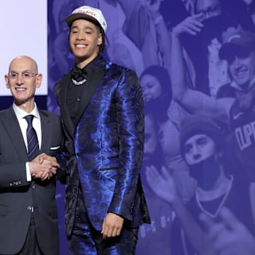 Penn State's Yanic Konan Niederhauser poses with NBA Commissioner Adam Silver after being selected as the 30th pick by the Los Angeles Clippers in the first round of the 2025 NBA Draft.