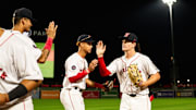 Roman Anthony high fives WooSox teammates following the Triple-A club's 12-2 win over Toledo on Tuesday at Polar Park.