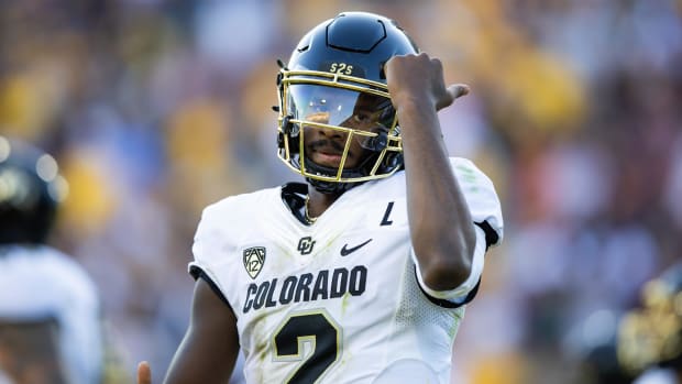 Buffaloes quarterback Shedeur Sanders celebrates after scoring a touchdown