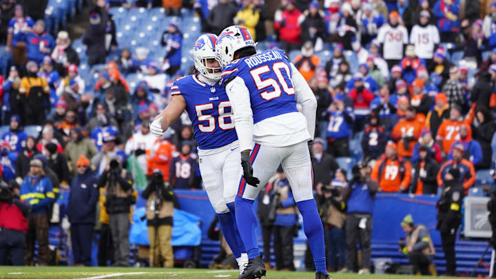 Jan 12, 2025; Orchard Park, New York, USA; Buffalo Bills linebacker Matt Milano (58) and defensive end Greg Rousseau (50) celebrate a sack during the fourth quarter against the Denver Broncos in an AFC wild card game at Highmark Stadium. Mandatory Credit: Gregory Fisher-Imagn Images